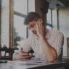 Frustrated Man Looking At His Laptop In A Cafeteria